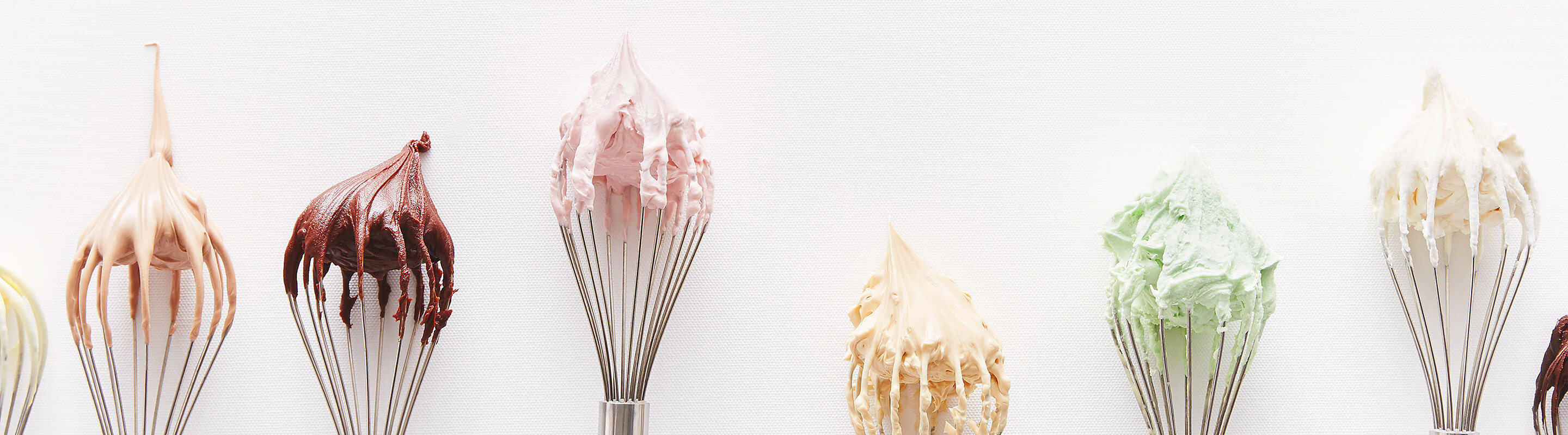 Delicious buttercream dipped whisks in chocolate, pistachio, raspberry, vanilla and hazelnut flavours